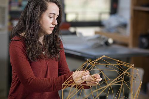 student working on art project