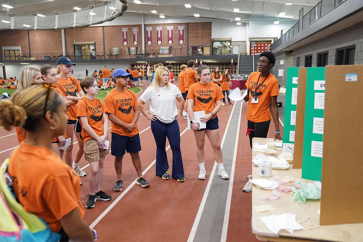 People dressed in orange learning about zero waste 