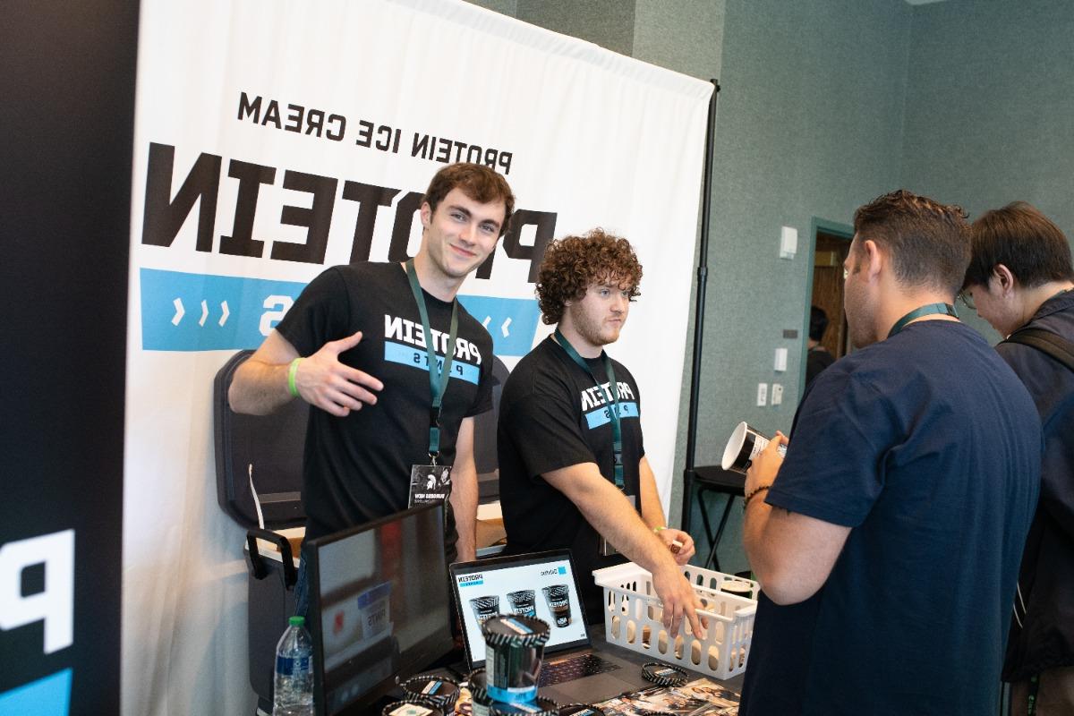 Paul Reiss and Mike Meadows at a table pitching their product