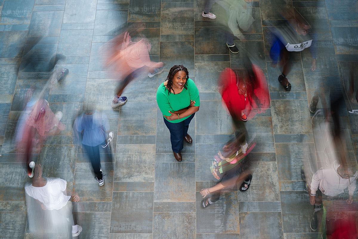 Dr. Keli Christopher pictured from above with blurred students running around her